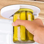 Jar positioned beneath the white cabinet-mounted opener