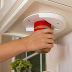 White under-cabinet V-grip opener being used with a jar