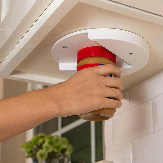 White under-cabinet V-grip opener being used with a jar