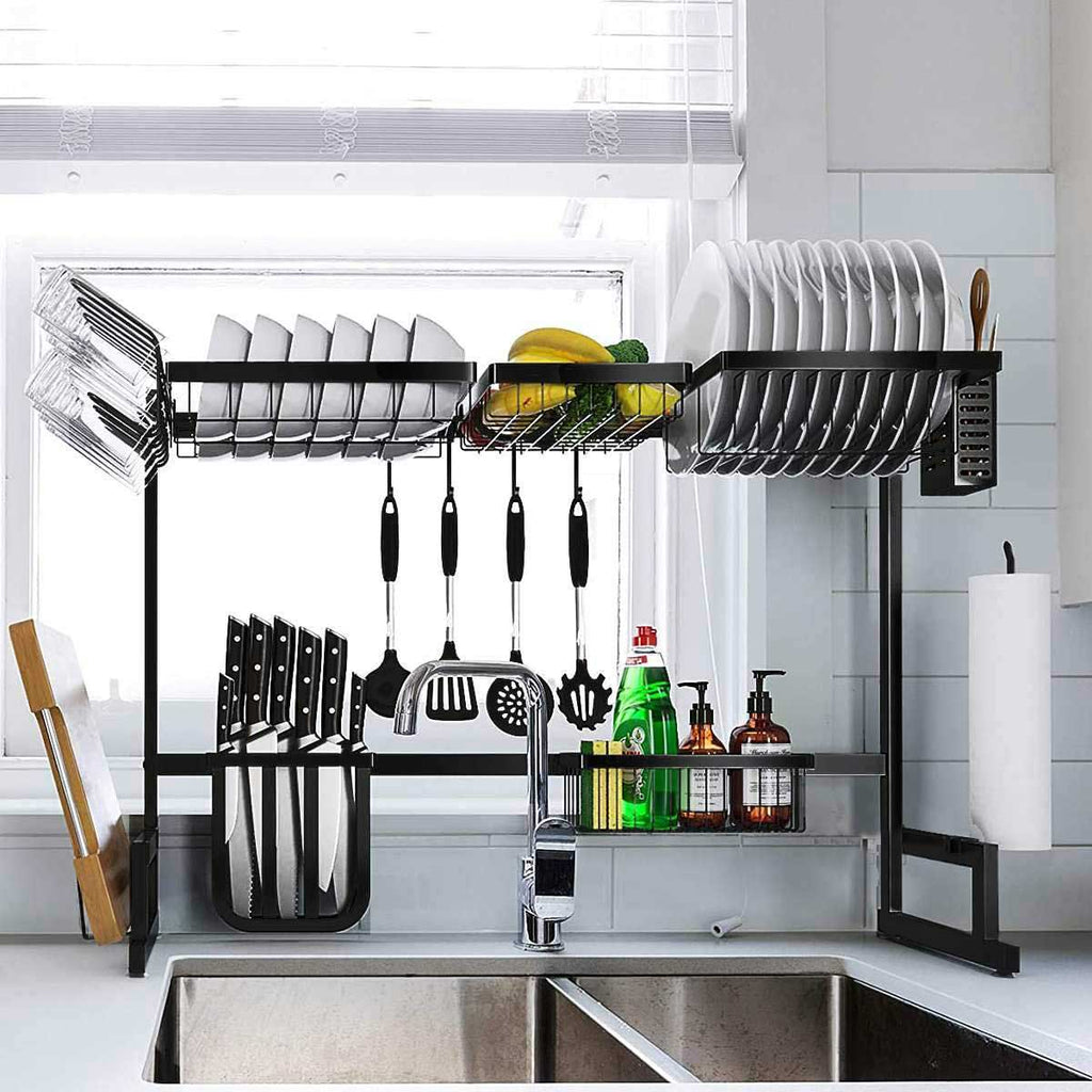 Black adjustable rack arranged over a sink; tableware and cleaning supplies are props